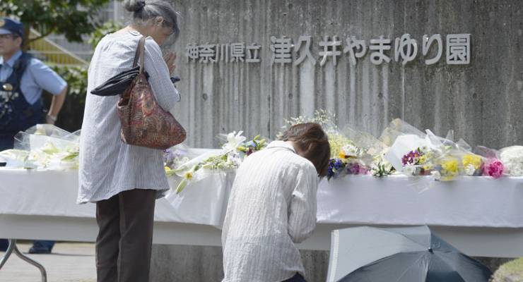 Mourners pay their respects at a memorial for the dead in Sagamihara