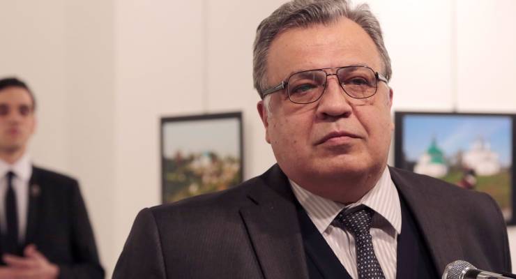Russian Ambassador to Turkey Andrey Karlov pictured moments before he was shot by Mevlut Mert Aydintas (left)