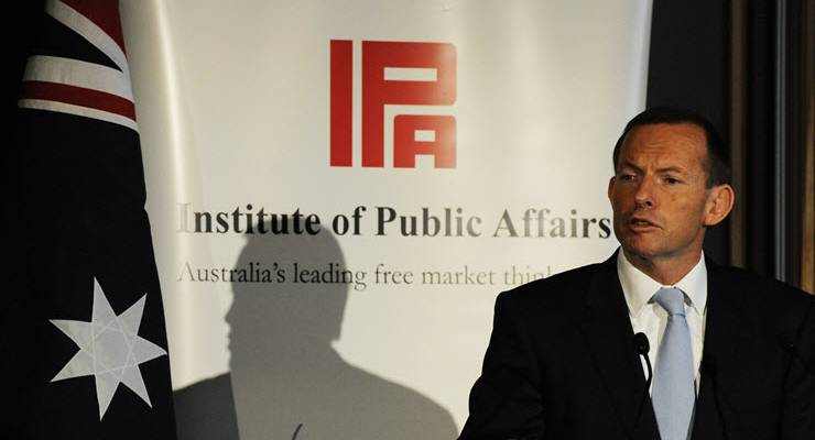 Tony Abbott in front of IPA sign.
