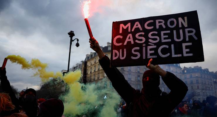 The protesters' sign reads: 'Macron, rioter of the century' (Image: