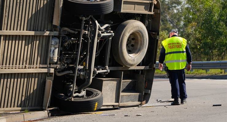 Police inspect a bus that rolled onto its side in the Hunter Valley, NSW (Image: AAP/AP/Mark Baker)