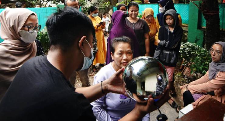 A woman has her irises scanned by WorldCoin's Orb (Image: WorldCoin)