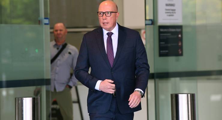 Opposition leader Peter Dutton walking out of an office building