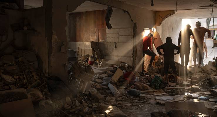 Palestinians in a house destroyed during an Israeli bombardment in Rafah, Gaza Strip (Image: AAP/AP/Fatima Shbair)