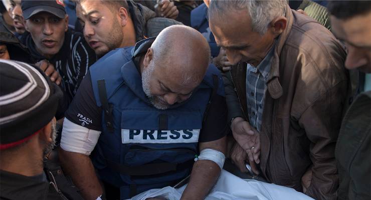 Al Jazeera Gaza bureau chief Wael Al-Dahdouh with relatives of Palestinian journalist Samer Abu Daqqa, cameraman for Al Jazeera, who was killed during Israeli air strikes (Image: AAP/Haitham Imad)